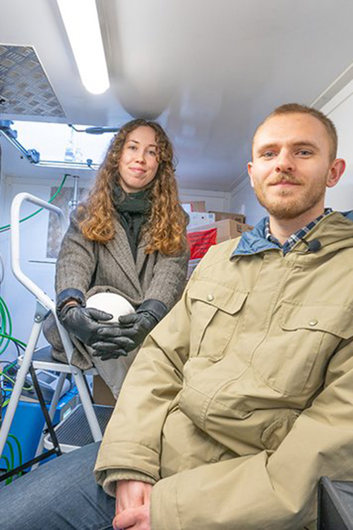 Laura and Jakob inside their mobile measuring station, which they designed and built in collaboration with the Danish Technological Institute in connection with the project “Renere Brænderøg”. Photo: Danish Technological Institute 